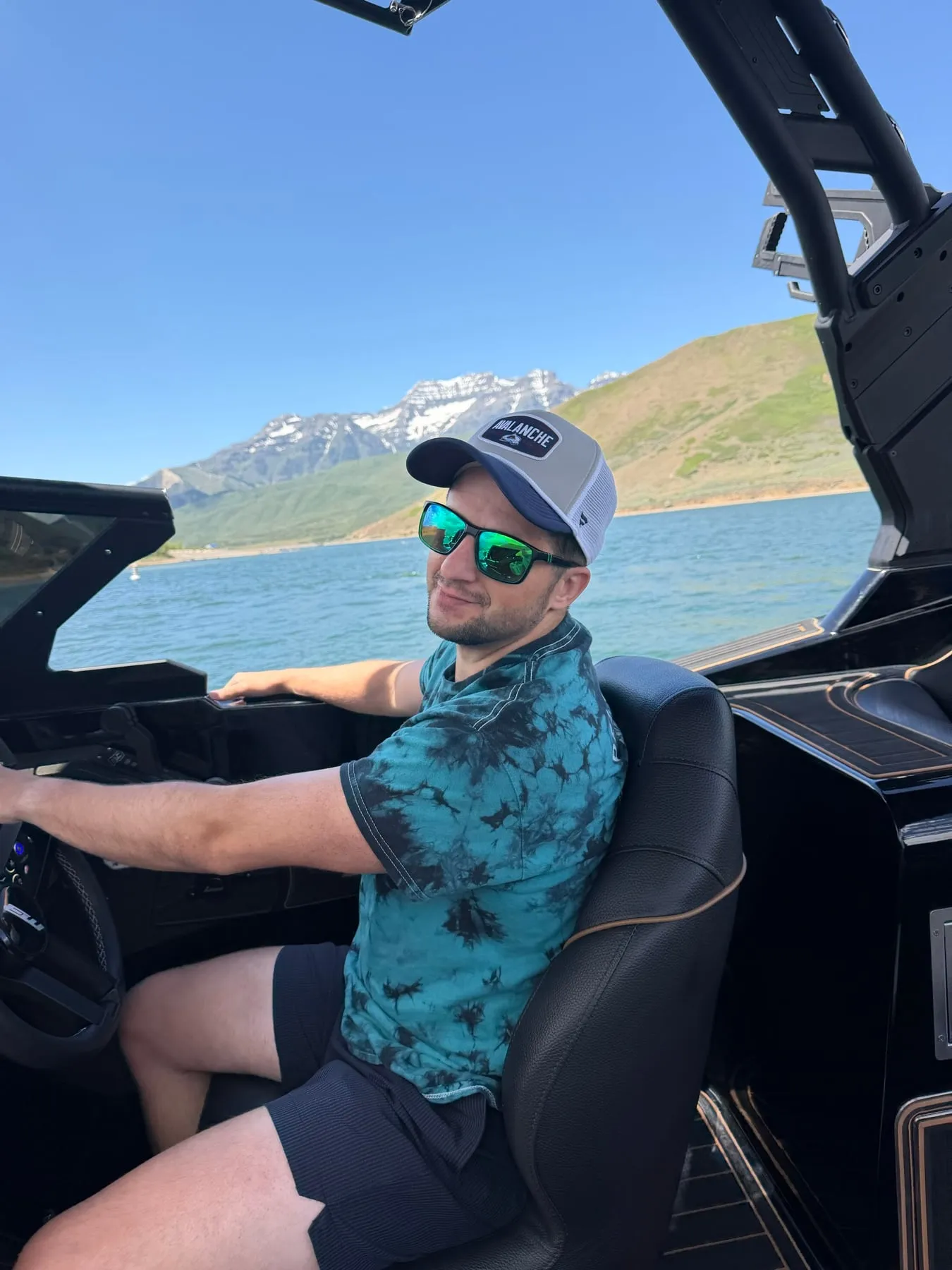 Dad driving a boat on a mountain lake in Utah